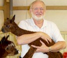 John Arnold holding 1 day old Alpaca Baby